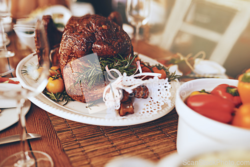 Image of Thanksgiving, food and roast meat for dinner on a dining table at a party, celebration or event. Christmas, chicken and luxury meal or feast at a festive holiday banquet to celebrate xmas at a house.