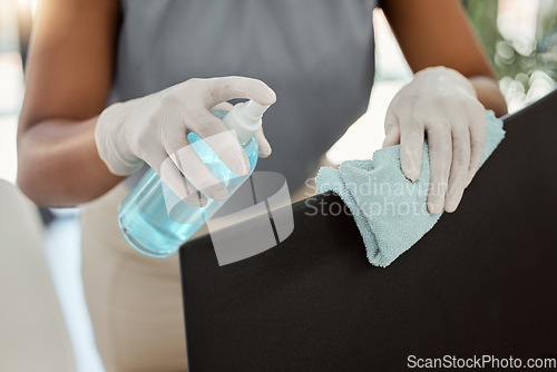 Image of Hands cleaning, sanitizer and chair in office for hygiene, safety and protection from covid 19 in workplace. PPE, cleaner woman and spray furniture for health at digital marketing business for covid