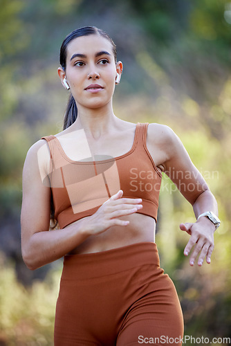 Image of Running, woman and outdoor fitness in the forest ready for sports, runner workout and walking hike. Health wellness training, exercise and cardio of an athlete with headphones on a run or speed walk