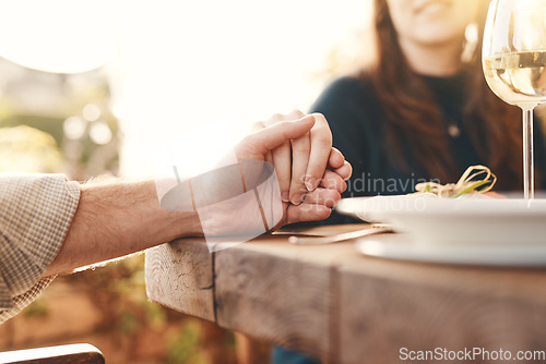 Image of Worship, table and people holding hands to pray for the meal, feast or dinner at an event. Prayer, celebration and christian family praying for the food before eating at party, celebration or banquet