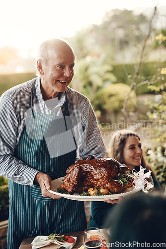 Image of Chicken, celebration and man serving lunch on Christmas holiday, family gathering and event in a backyard. Food, cooking and chef with a turkey for hungry people at a Thanksgiving dinner party