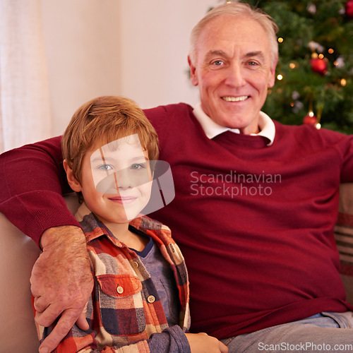 Image of Elderly man, grandson and christmas portrait on sofa with love, bonding or happiness in family home. Boy, grandfather and smile together for celebration, holiday or happy on couch in house by tree