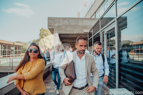 Image of A diverse group of businessmen and colleagues walking together by their workplace, showcasing collaboration and teamwork in the company.