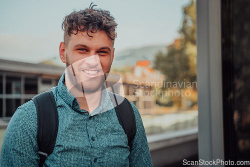 Image of A portrait of a modern man, exuding confidence and style, against an outdoor backdrop, showcasing his charisma and fashionable demeanor.