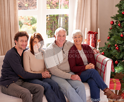 Image of Christmas, family and together on sofa for portrait in living room to celebrate festive holiday. Quality time, relax and happy family relax for bonding, support and care on couch for celebration