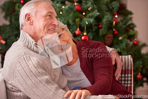 Image of Christmas, love and senior couple hug on sofa in home, affection and bonding. Romance, xmas holiday and happy elderly, retired woman and man embrace on couch enjoying quality time together in house