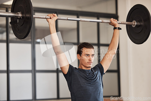 Image of Strong man, overhead barbell and gym exercise, workout and fitness training in sports club. Young man, focus bodybuilder and power press, weightlifting challenge and muscle, motivation and energy