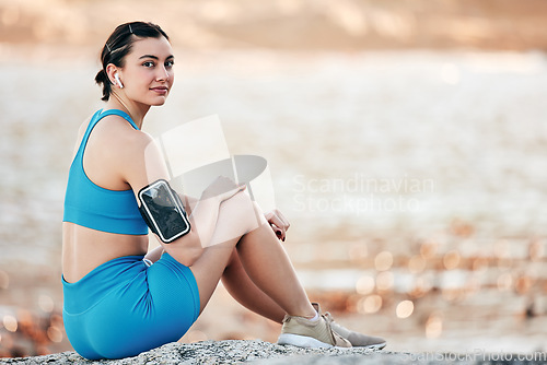 Image of Arm band, young woman and fitness outdoor, for workout and exercise for wellness and health. Portrait, female athlete and girl with equipment for training, relax and practice for calm and mockup.
