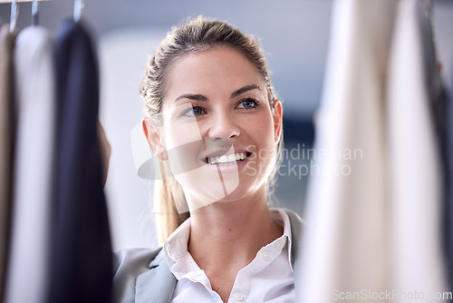 Image of Shopping, clothes and woman in a store for fashion choosing an outfit with material, fabric and texture. Happy, smile and girl looking at fancy or formal clothing in a retail shop or boutique.