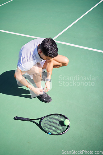 Image of Tennis, tie and man with shoes on a court for sports training, fitness exercise or cardio workout in summer in Spain. Wellness, athlete or tennis player ready to start playing a game on tennis court