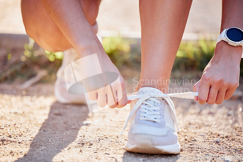 Image of Shoes, running and fitness person hands in nature tie laces to start a run, hike or walk. Exercise, training and running workout of an athlete ready for outdoor travel walking for health and sport