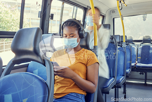 Image of Bus, travel and covid woman on a phone and headphones for corona virus update, listening to news and social media report on journey. Girl covid 19 face mask, technology and transport rules for safety