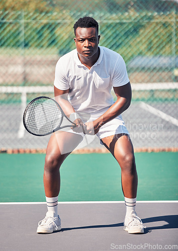 Image of Tennis, sports and black man in portrait for game, competition and training with focus, power and energy wellness. Strong, athlete and fitness african in tennis court for outdoor body exercise