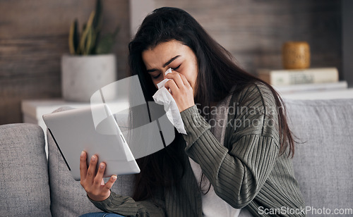 Image of Tablet, sad and crying with a woman on a video call or reading an ebook on the living room sofa or her home. Internet, reading and breakup with a female on the couch, wiping her tears after a cry
