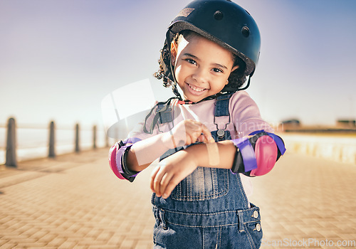 Image of Skating injury, first aid or child portrait with bandage bruise from skate, cycling or accident in street. Happy, smile or girl with helmet for exercise, wellness health at beach, sea or ocean