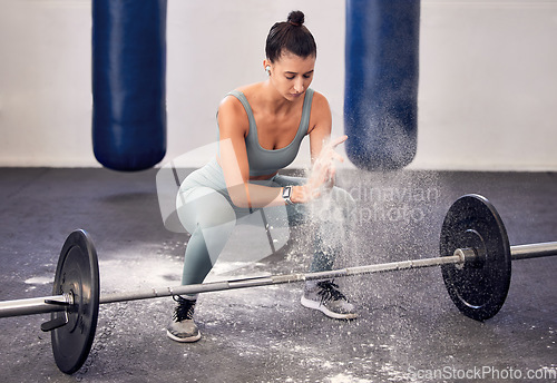 Image of Woman, bodybuilder and powder in gym for barbell on hands for, safety, wellness and fitness. Girl, deadlift and weightlifting for workout, crossfit and strong body with power, muscle and healthy