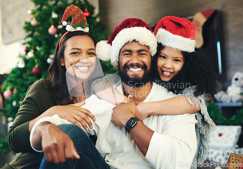 Image of Christmas, happy and portrait of family in living room for celebration, affection and festive. Holiday, smile and bonding with girl hug parents at home for content, gratitude and xmas vacation