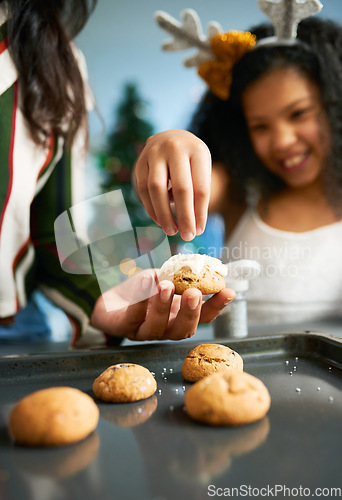 Image of Hands, cookies and baking with a mother and daughter in the kitchen on Christmas for the festive season. Family, children and food with a woman and girl learning hoe to bake together at home