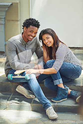 Image of Portrait, skateboard and friends relaxing in the city while bonding with happiness for fun. Skater, man and woman with friendship bond for active lifestyle in an urban town while skateboarding