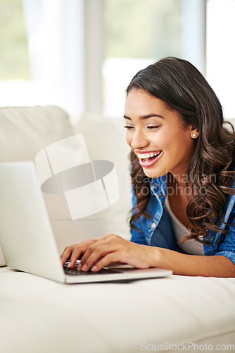 Image of Woman, laptop and smile for good news on sofa reading email, blog or relaxing in social media at home. Happy excited female in online conversation, sale or computer connection on living room couch