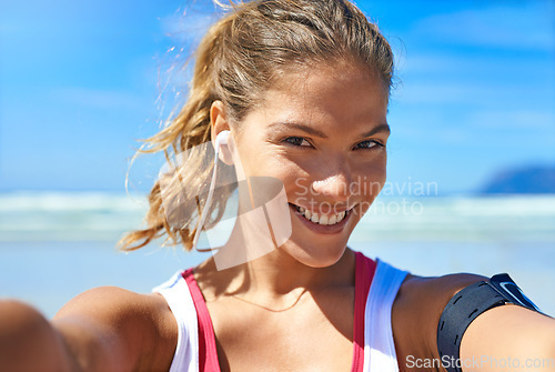 Image of Fitness, selfie and happy woman at beach workout, exercise and healthy lifestyle with music. Portrait female athlete, ocean and taking photograph for social media, sports wellness and summer training