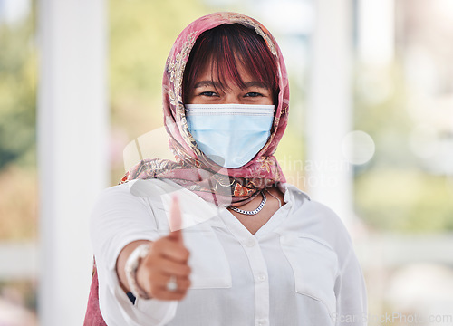 Image of Thumbs up, Islamic woman and mask for covid protection, vaccine and health outdoor. Muslim female, hand gesture or healthy lady with face cover, corona and safety regulations for virus and infection.