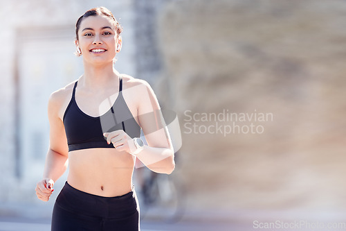 Image of Running, exercise and happiness with a woman outdoor for fitness, workout and cardio training in a city with free space, energy and commitment. Runner with a smile for sport, motivation and health