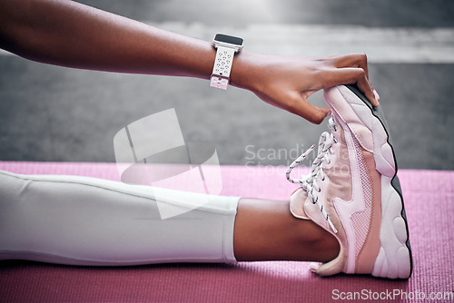 Image of Fitness, feet and woman stretching, sneakers and legs on mat for sports training, exercise and yoga workout. Closeup of female athlete touching shoes, foot and warm up, wellness and healthy lifestyle