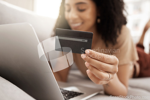 Image of Hand, credit card and online shopping with a black woman customer using her laptop in the living room. Finance, computer and accounting with a female consumer spending money through ecommerce