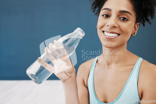 Image of Drinking water, fitness and black woman in workout studio with blue wall mockup for healthy lifestyle, wellness and nutrition. Portrait of sports, athlete or yoga woman with water bottle for exercise