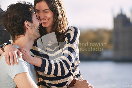 Image of Love, travel and happy with couple in London for adventure, vacation and destination. Affectionate, hug and smile with man and woman in city at river thames for holiday, embrace and abroad trip
