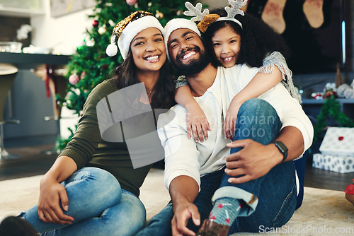 Image of Portrait, Christmas and family celebration, happy or embrace together in living room. Xmas, love and mother with father, daughter and smile for holiday, hug or vacation for happiness, content or joy