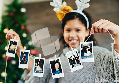 Image of Girl portrait, polaroid and christmas celebration, happy smile and memories, photograph and decoration in home. Child, picture and string for xmas, celebrate and festive holiday, happiness and kid