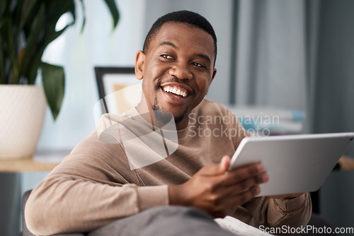 Image of Black man, digital tablet and social media, living room home and streaming app, reading ebook or online shopping on technology. Happy guy, wifi connection and relax in lounge, wifi internet and ideas