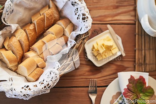 Image of Buffet table, flatlay of bakery bread with butter in buffet and kitchen counter with wood texture background. Restaurant with brunch food, healthy meal for dinner and plate of lunch with cutlery