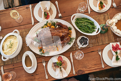 Image of Christmas lunch, top view and food on wood table of dining room for healthy meal, festive celebration and holiday event. Formal meal, roasted chicken and healthy thanksgiving dinner party at home