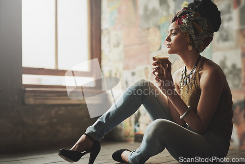 Image of Coffee, relax and thinking black woman on the floor of a living room with fashion in her apartment. Idea, style and African girl content with tea drink, peace and calm in the lounge of her house