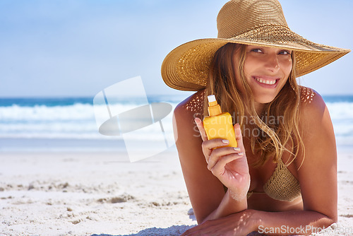 Image of Young woman, beach and sunscreen for protection, smile and happiness on sand. Female, girl with suntan lotion for skincare, prevent sunburn and happiness on vacation with sun blocker and seaside.