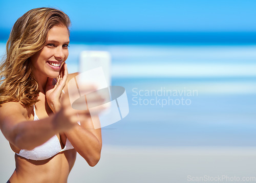 Image of Influencer, phone and woman taking a selfie at a beach for a social media audience or travel blog online in Sao Paulo, Brazil. Model, content creator or happy girl taking pictures in summer in bikini