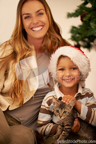 Image of Portrait of family on Christmas, child with cat and mother on festive holiday together in Dallas home. Happy mom giving kitten as gift to kid, celebration of love with pet or relax by christmas tree