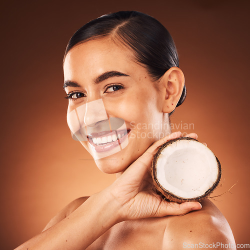 Image of Coconut, woman and beauty, skincare and portrait, cosmetics and healthy food for diet, aesthetics and body nutrition benefits on studio background. Happy young model, coconut oil and natural wellness