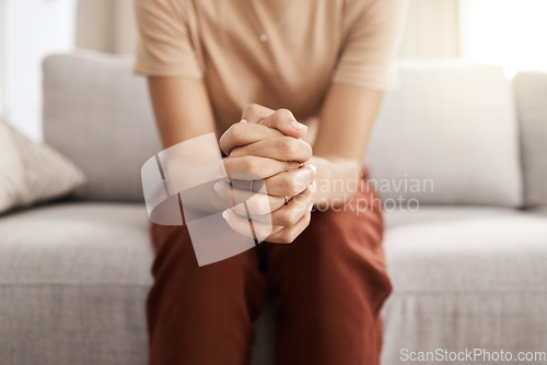 Image of Stress, worry and hands of woman on sofa with mental health issue, problem and anxiety at home. Depression, sadness and close up of connected hand of girl with fear, nervous and stressed expression