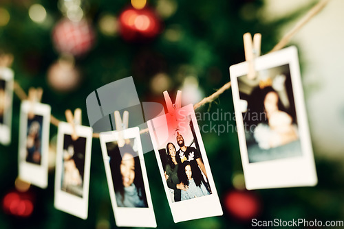 Image of Christmas, family and photo hanging for decoration on peg line for festival, tradition and vacation at home. Photography, holiday celebration and canvas pictures of people to decorate Christmas tree