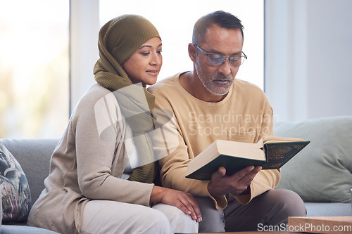 Image of Muslim couple, reading Quran and spiritual with islam, hijab and book for faith, trust and learning scripture in home. Islamic man, woman and read religious book, support and learn on eid Mubarak