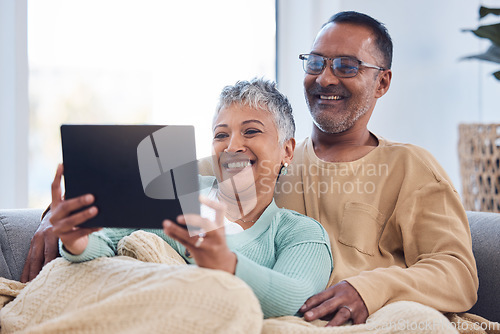 Image of Love, senior couple and tablet on sofa, social media or online reading together in lounge. Mature man, elderly woman or device to search internet, bonding or loving for video call, happiness or relax