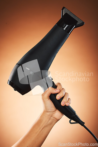 Image of Hair, hand with hair dryer and hair care with beauty and cosmetic advertising against orange studio background. Salon, hairdressing and hairstyle tool or appliance with cosmetics marketing.