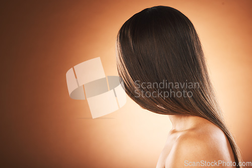 Image of Hair care, shine and woman marketing a salon, hairdresser mockup and space on a brown studio background. Brunette, luxury advertising and model with straight hair from hair salon with mock up