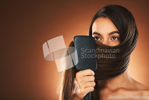 Image of Hair care, salon and woman brushing hair, beauty glow and mockup space against brown studio background. Luxury shine, clean and model with a brush for hairdresser styling and advertising with mock up