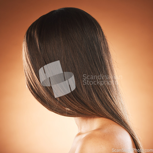 Image of Woman, texture or hair style on orange studio background in keratin treatment marketing, Brazilian straightening advertising or self care. Model headshot, brunette color aesthetic or mockup backdrop