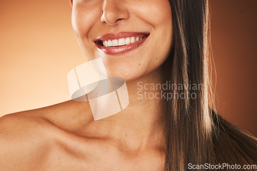 Image of Happy, smile and woman with hair care, skincare and beauty cosmetic treatment in a studio. Happiness, health and girl model with a wellness facial skin routine isolated by a gradient brown background
